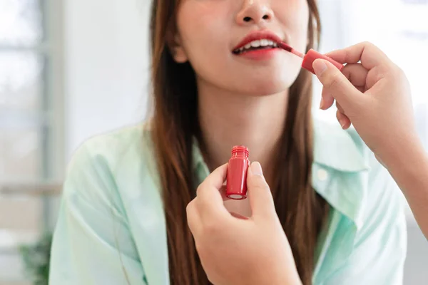 Beauty and cosmetic concept, Makeup artist applying lipstick and professional makeup for model.