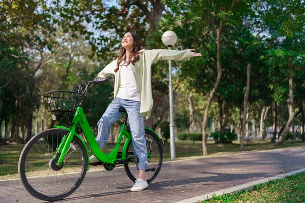 Women Riding Bicycle Spreads Arms Enjoying Fresh Air While Exercise — Stock Photo, Image