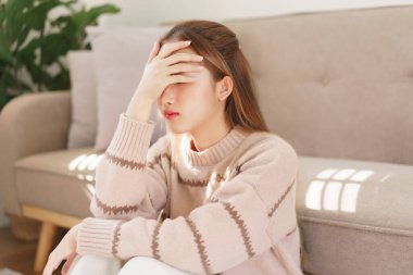 Dinlenme zamanı konsepti, kadınlar yerde oturuyor ve acı çeken alnına dokunuyorlar..