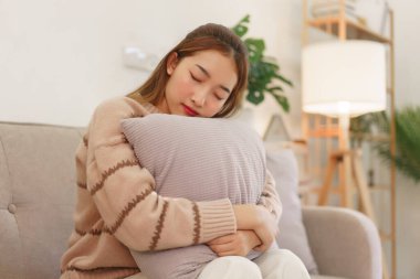 Leisure time concept, Women are hugging pillow and asleep while sitting on the couch to relaxation.