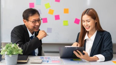 Business partnership concept, Businesswoman pointing at document during senior consultation.