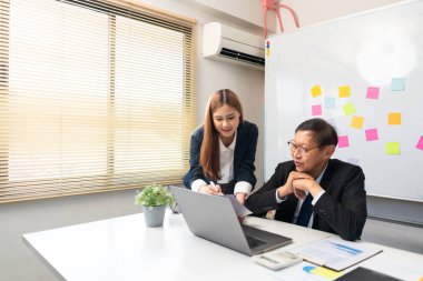 Business partnership concept, Businesswoman pointing at document to presenting project to senior.