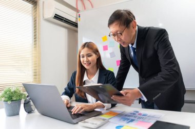 Business partnership concept, Businesswoman is typing on laptop during senior explain project data.