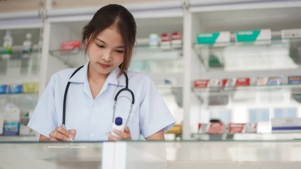Medicine Health Concept Female Pharmacist Hold Pill Bottle Write Prescription — Zdjęcie stockowe