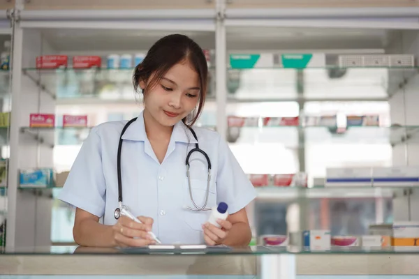 Medicine Health Concept Female Pharmacist Hold Pill Bottle Write Prescription — Zdjęcie stockowe