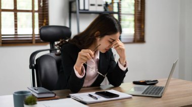 İş kadını bardakları tutuyor ve aşırı çalışmaktan bitkin düştükten sonra burnuna masaj yapıyor..