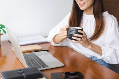 İş kadınları kahve içer ve laptopta ofis dışındaki yeni girişimleri düşünmek için veri okurlar..