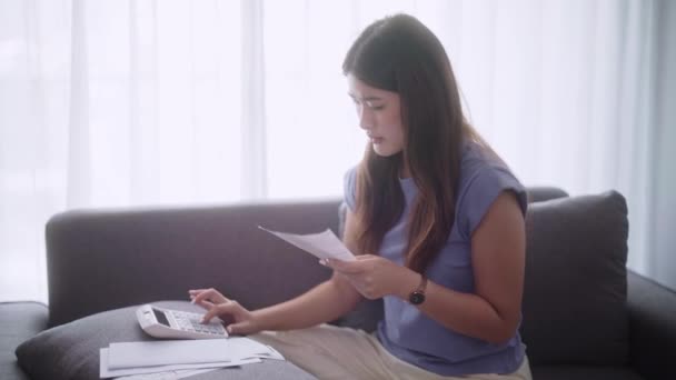 Young Adult Asian Woman Calculating Home Expenses Invoice Tax Bills — Stock Video