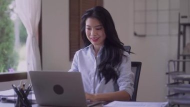 Elegant business Asian woman very happy cheering with clenched fists at office desk finish project work at her office. High quality 4k footage