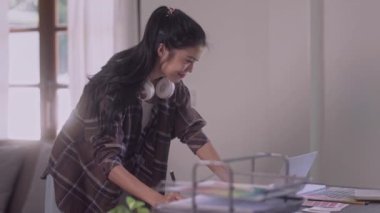 Young Asian Women Graphic designer Artist work on computer laptop and with graphic interactive drawing pen sitting in front of window at desk in office. High quality 4k footage