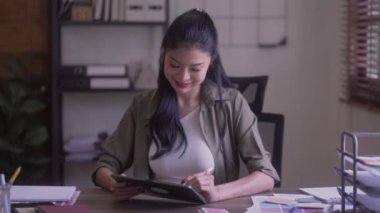 Young Asian Graphic designer woman with digitized a stylus pen drawing illustration on graphics tablet at home. High quality 4k footage