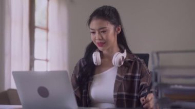 Young Asian Women Graphic designer Artist work on computer laptop and with graphic interactive drawing pen sitting in front of window at desk in office. High quality 4k footage