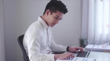 Asian Businessman using laptop computer Does Data Analysis Works on e-Commerce Startup in office. High quality 4k footage