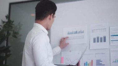 Asian Businessman using laptop computer Does Data Analysis Works on e-Commerce Startup in office. High quality 4k footage