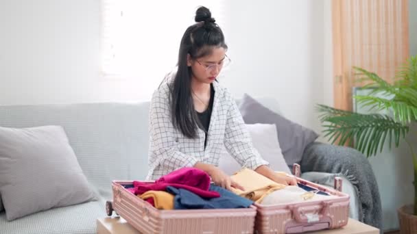 Mulher Asiática Eficientemente Rola Embala Roupas Compactamente Preparando Para Encaixá — Vídeo de Stock