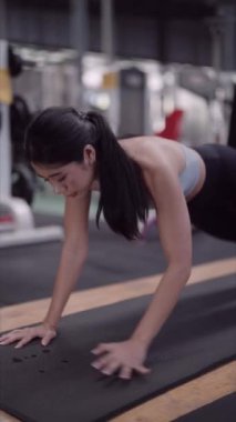 Asyalı kadın, sağlık meraklısı, kalaslarla etkili abdominal egzersizler yapıyor. Kendini spora adadı, güçlü çekirdek kasları geliştirdi. Yüksek kalite 4k görüntü