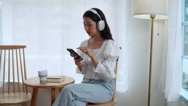 Azjatycka Przedsiębiorczyni Rozwijająca Się Pobliskiej Kawiarni Wybierająca Piosenki Swoim Smartfonie — Wideo stockowe