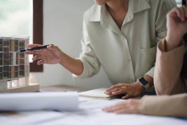 İki kadın mimar plandaki model ve iç tasarım hakkında tartışıyor ve beyin fırtınası yapıyor..