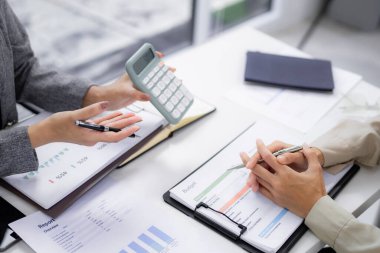 Business hands collaborate analyzing financial reports Professionals review budget allocations discussing strategic planning wealth management in office