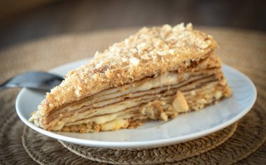 Yellow honey cake on white plate