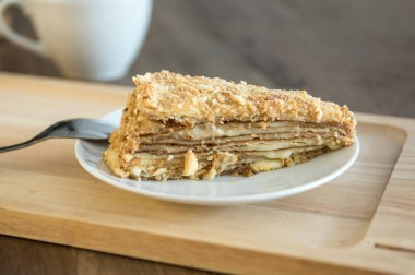 Yellow honey cake on white plate