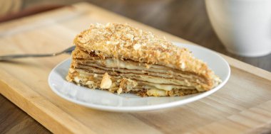 Yellow honey cake on white plate