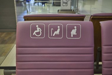 Disabled Handicap sign on a chair reserved for people with disabilities, elderly and pregnant women clipart