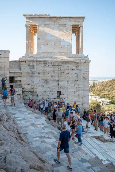 stock image Tourists visiting the Acropolis of Athens, main ancient sightseeing site in the capital of Greece on 15 August 2023