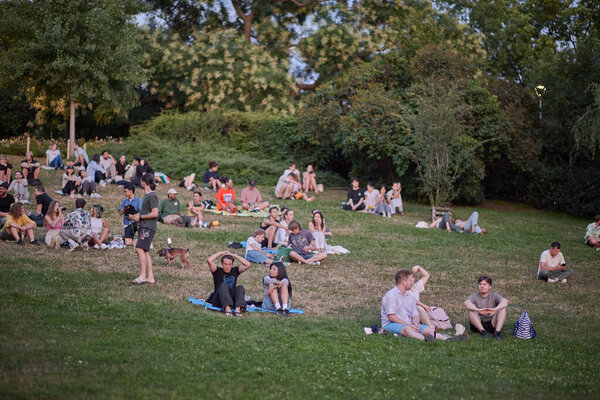 Young people picnic and enjoy sunset view of Prague cityscape in summer in Riegrovy Sady park in the Vinohrady district in Prague, capital of Czech Republic on 22 July 2024