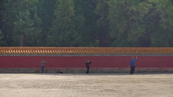 stock image Group of people practicing tai chi in a park, in Beijing, capital of China on 21 April 2024