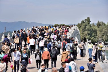 Tourists visiting the Summer Palace, complex of gardens and palaces in Beijing, capital of China on 20 April 2024 clipart