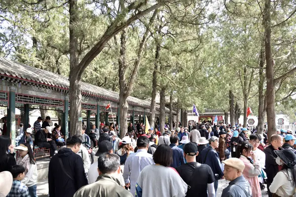 stock image Tourists visiting the Summer Palace, complex of gardens and palaces in Beijing, capital of China on 20 April 2024