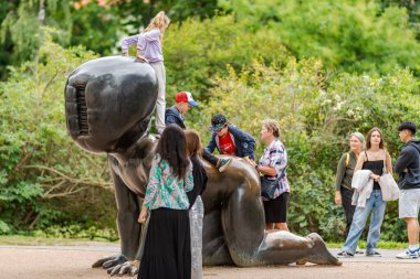 Tourists visiting The Babies at Kampa park museum, bronze sculptures of crawling babies with mutant faces by controversial Czech artist David Cerny, in Prague, Czech Republic on 03 July 2024 clipart