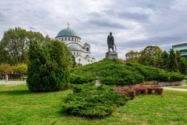 Monument dedicated to Karadjordje, leader of Serbian Uprising (1804-1813) and Saint Sava church in the background, in Belgrade, Serbia on 3 October 2024 clipart