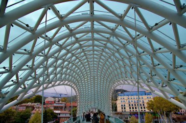 Bridge of Peace, steel and glass construction pedestrian bridge over Kura Mtkvari river in central Tbilisi, capital of Georgia, on 21 October 2024 clipart