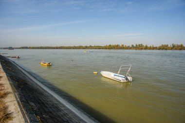 Small colorful fishing boats scattered across the Danube river in Belgrade, capital of Serbia clipart