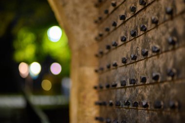 Metal door at gate in Belgrade Fortress fortifications in Kalemegdan park at night in Belgrade, capital of Serbia clipart