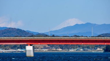 View of Hamanakako, Lake Hamana, brackish lagoon lake connected to the Pacific Ocean in Hamamatsu, Shizuoka prefecture of Japan, with snowcapped Mount Fuji visible in the distance clipart