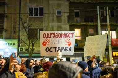 Serbian students and citizens protest against government corruption after Novi Sad railway station accident, in Slavija square in Belgrade, Serbia on 22 December 2024 clipart