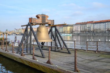 Bell #9801 on a pontoon in the Vltava river, commemorating cultural loss of 9801 bells taken by Nazis from churches in the Czech Republic during the WW2, in Prague, Czechia on 20 January 2025 clipart