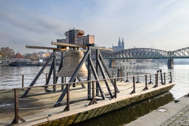 Bell #9801 on a pontoon in the Vltava river, commemorating cultural loss of 9801 bells taken by Nazis from churches in the Czech Republic during the WW2, in Prague, Czechia on 20 January 2025 clipart