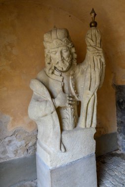 Statue at the Italian Court palace, former seat of the central mint of Bohemia, royal residence and town hall in Kutna Hora, Czech Republic on 25 January 2025 clipart