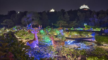 Night view of illuminated Jingshan Park, Chinese imperial garden in Beijing, China on 18 April 2024 clipart