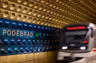 Train arives at Jiriho z Podebrad metro station decorated with modern coloured aluminium panels, in Prague, capital of Czech Republic on 7 February 2025 clipart