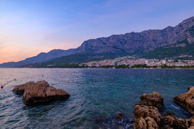 Hırvatistan 'ın Adriyatik kıyı şeridinde 24 Ağustos 2024' te Makarska kenti üzerinde gün batımı, popüler turistik sahil tatil beldesi