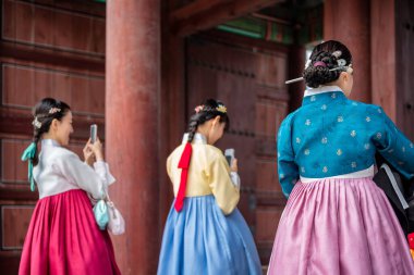 Geleneksel Koreli Hanbok elbiseli turistler 23 Ekim 2022 tarihinde Güney Kore 'nin başkenti Seul' deki Joseon hanedanlığının Changdeokgung kraliyet sarayını ziyaret ettiler.