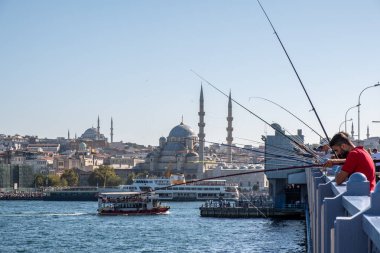 10 Eylül 2022 'de İstanbul' da tarihi eski kenti Karaköy 'e bağlayan Galata Köprüsü' nde balık tutan insanlar görülüyor.