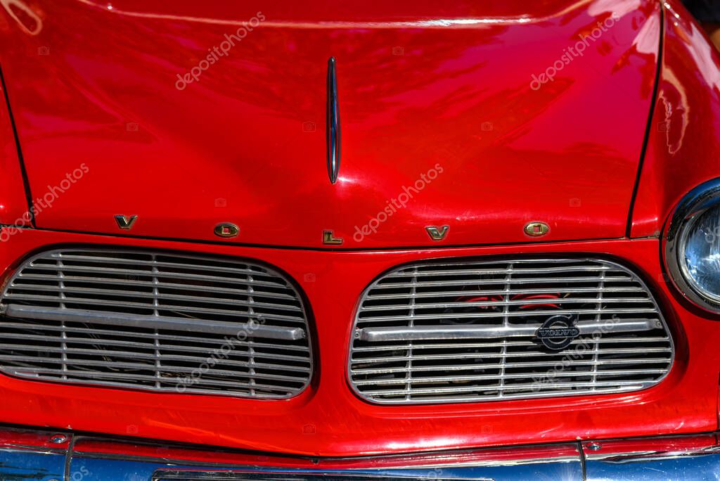 Close-up of a vintage red Volvo car front with grille and emblem at the Belgrade Grand Prix 2024 show of vintage and old timer cars in Belgrade, Serbia on 28 September 2024