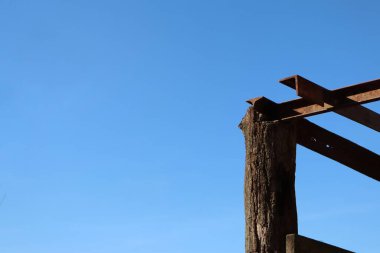 a closeup shot of a wooden house on a blue sky background