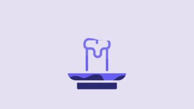 Blue Burning candle icon isolated on purple background. Cylindrical aromatic candle stick with burning flame. Happy Halloween party. 4K Video motion graphic animation.